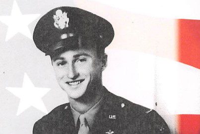 A smiling soldier in military uniform.