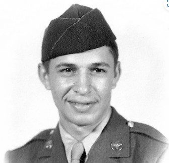 Black and white portrait of a young man in uniform.