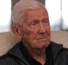 A close-up portrait of an elderly man.