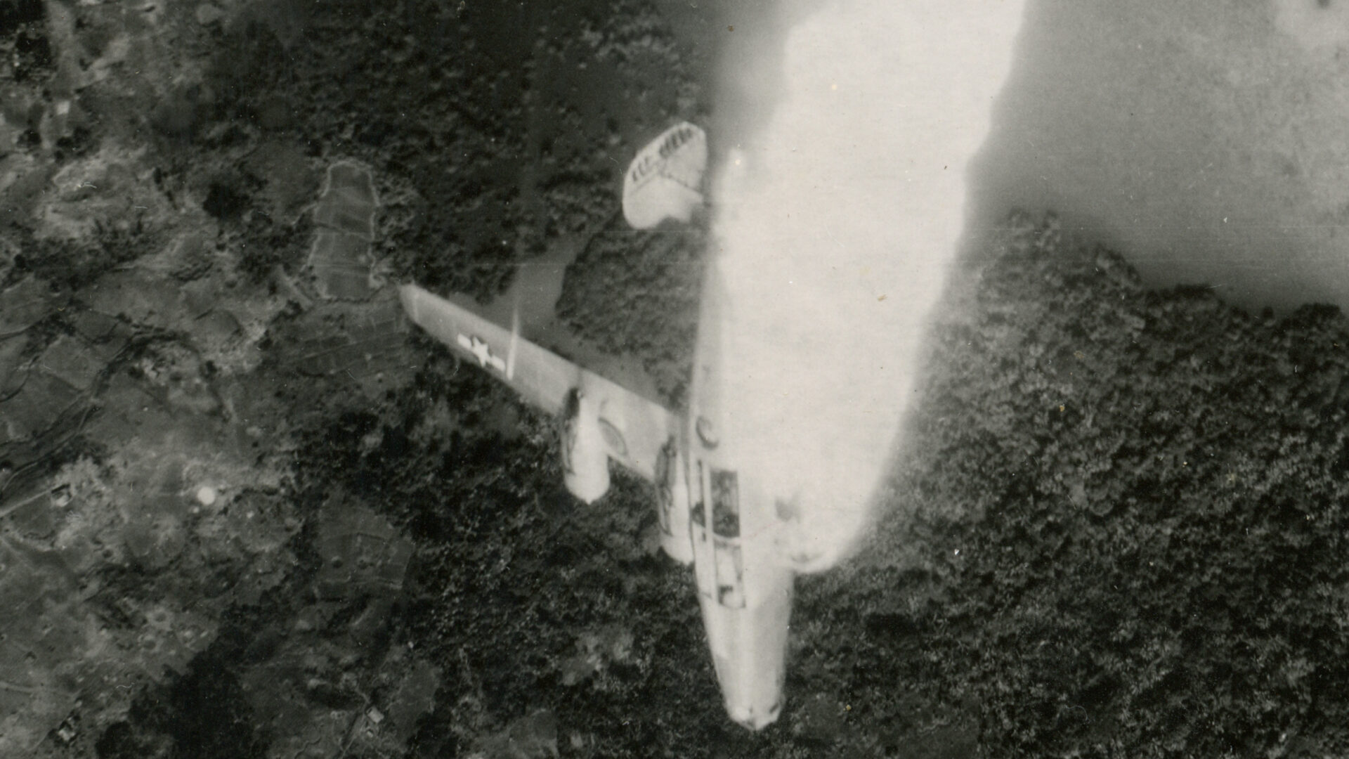 Aerial view of a plane crashing into trees.