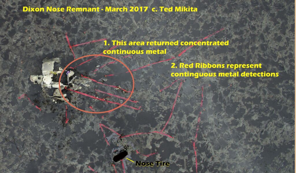 Airplane nose wreckage with metal detection markings.